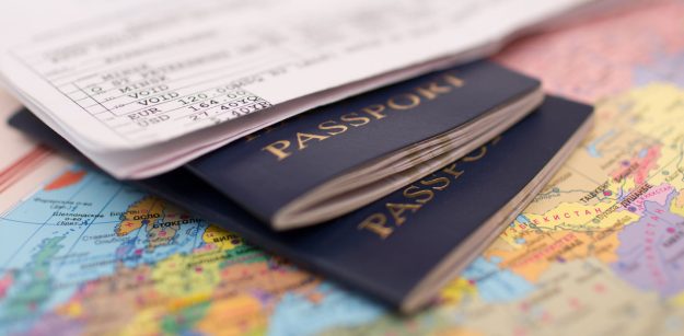 2 grey Passports on a World map | Kenyan Immigration Law & Process | Njaga & Co. Advocates Immigration law firm