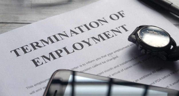 A termination of employment document with a smartphone and watch on it |Termination Under Kenyan Employment Law | Njaga & Co. Advocates employment law legal articles