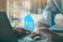 A person using a laptop with virtual icons representing property due diligence elements such as a house, location pin, checklist, and dollar sign, symbolizing real estate research and transactions | A Simplified/ Comprehensive Guide to Due Diligence in Property Transactions in Kenya | Njaga Advocates real estate lawyers