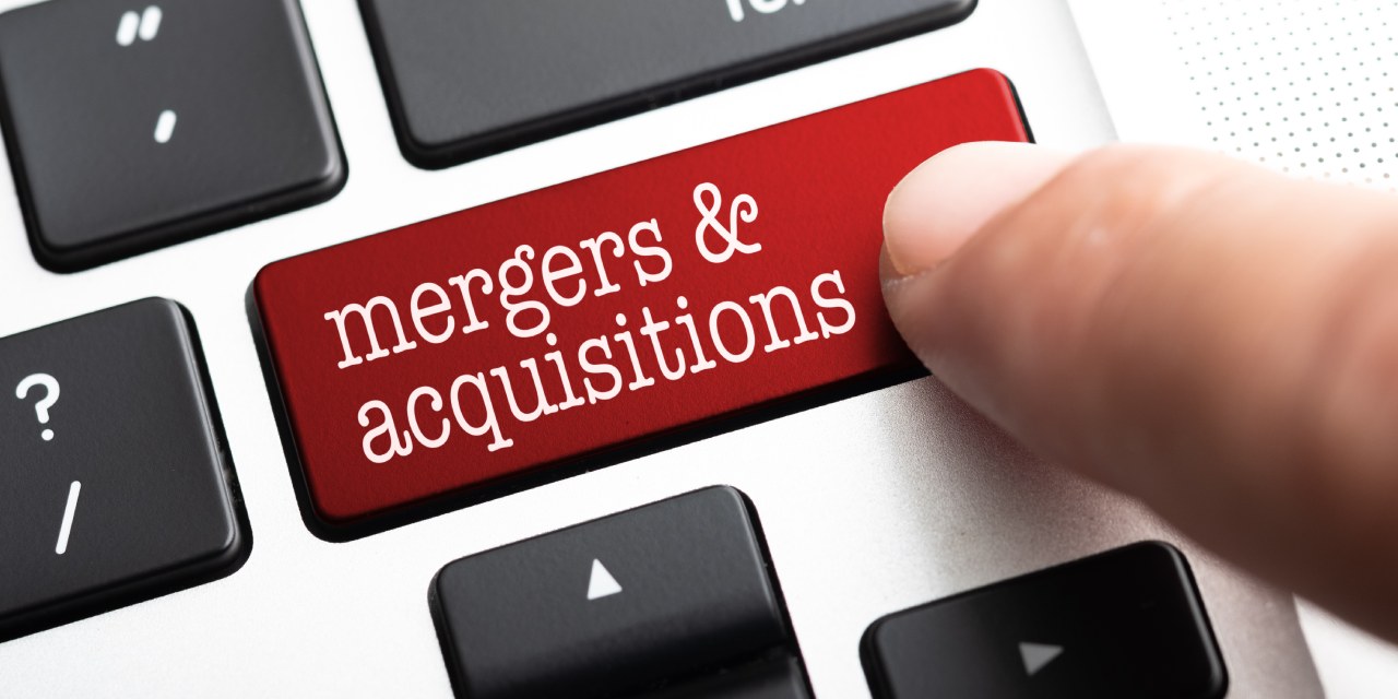 Laptop keyboard with a button reading mergers & acquisitions | Understanding legal framework of mergers and acquisitions in kenya | Mergers and acquisitions lawyer in Nairobi | Njaga & Co Advocates LLP